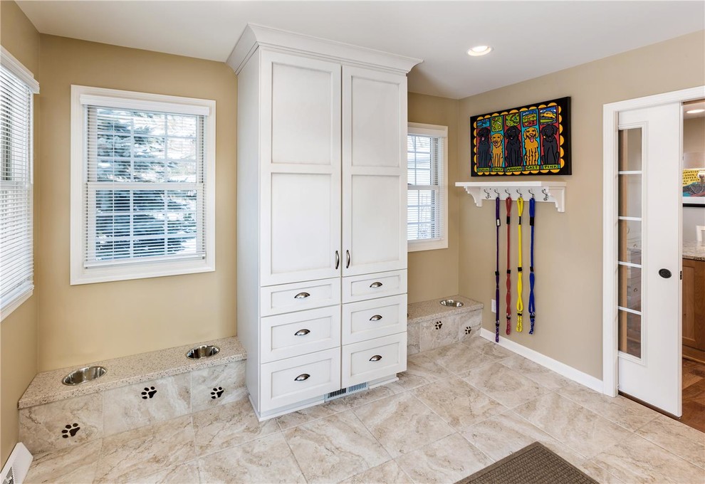 Inspiration for a mid-sized contemporary single-wall ceramic tile utility room remodel in New Orleans with a drop-in sink, recessed-panel cabinets, white cabinets, granite countertops and beige walls