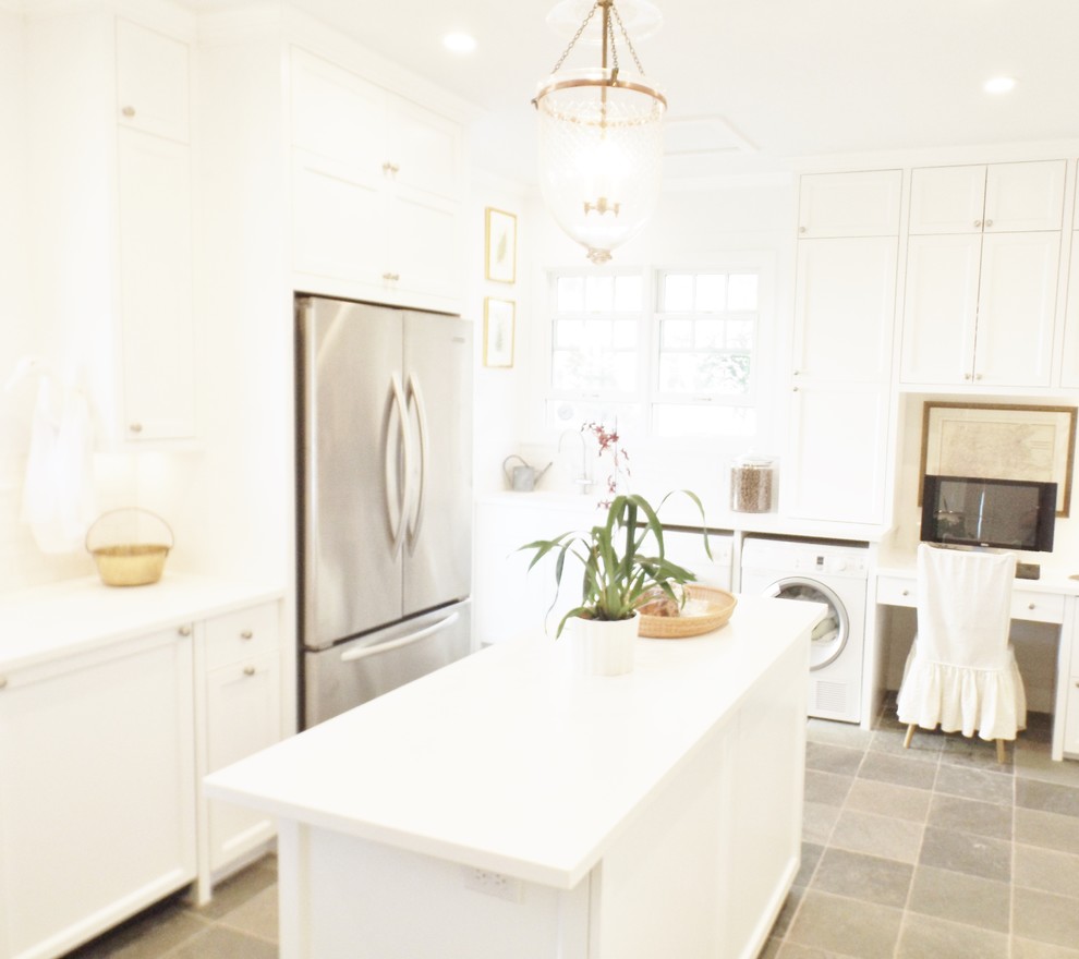 Inspiration for a large contemporary l-shaped limestone floor and gray floor utility room remodel in Hawaii with shaker cabinets, white cabinets, white walls and a side-by-side washer/dryer