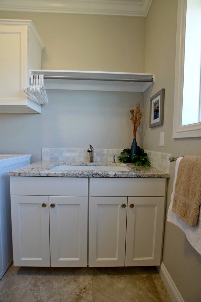 Inspiration for a classic single-wall separated utility room in Denver with a submerged sink, shaker cabinets, white cabinets and a side by side washer and dryer.