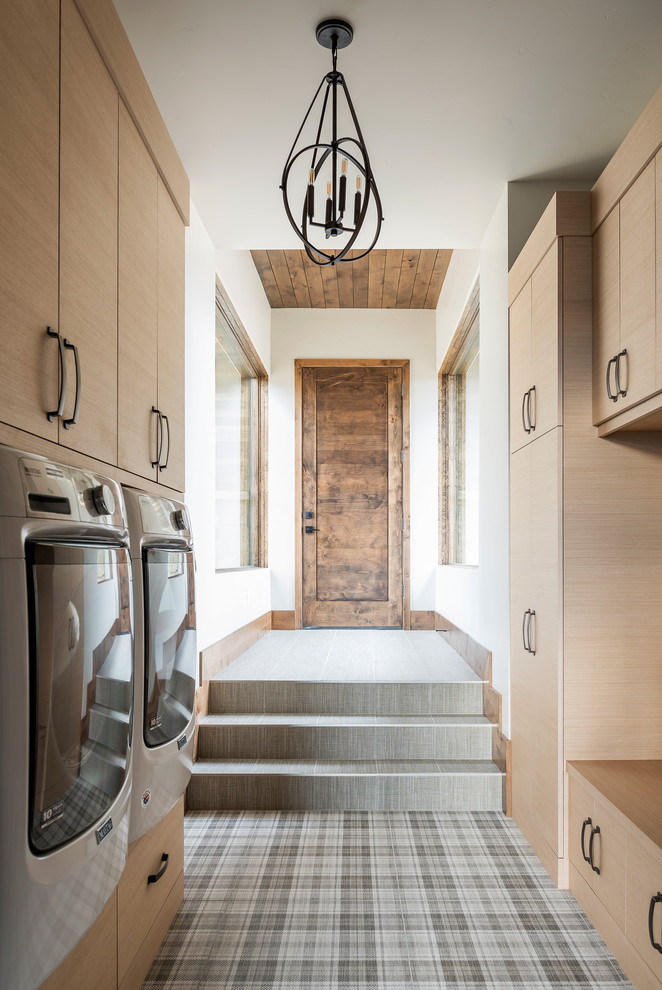 Rustic galley separated utility room in Salt Lake City with flat-panel cabinets, light wood cabinets, white walls and a side by side washer and dryer.