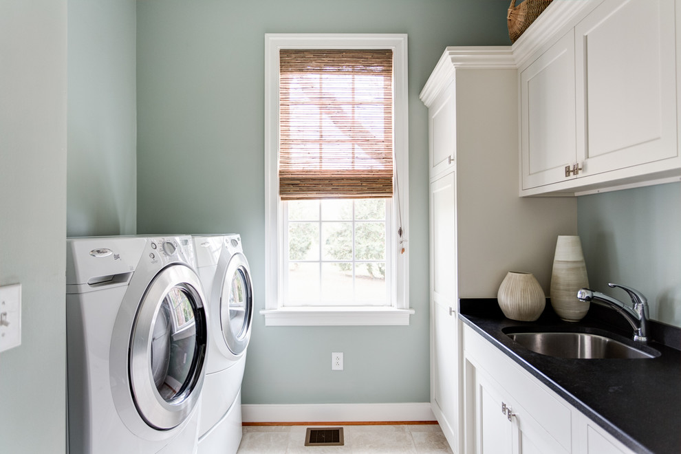 Design ideas for a traditional galley utility room in Other with a submerged sink, white cabinets, soapstone worktops and a side by side washer and dryer.
