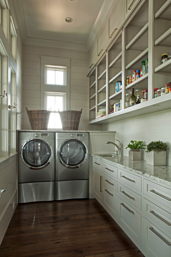 Elegant l-shaped laundry room photo in Miami with a side-by-side washer/dryer