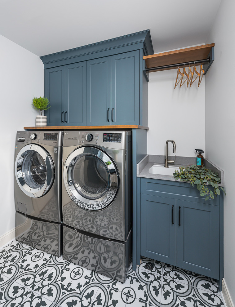 Example of a large transitional porcelain tile and brown floor laundry room design in Chicago with flat-panel cabinets, white cabinets and white walls