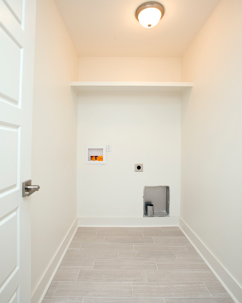 Foto de armario lavadero de galera moderno pequeño con paredes blancas, suelo de baldosas de porcelana y lavadora y secadora juntas