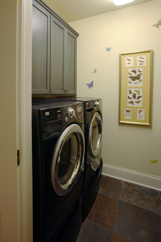 Laundry room - small traditional galley laundry room idea in Cincinnati with shaker cabinets, gray cabinets, beige walls and a side-by-side washer/dryer