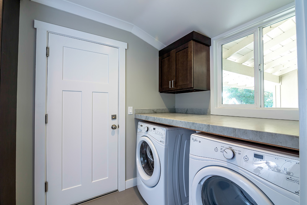Inspiration for a mid-sized contemporary porcelain tile laundry room remodel in San Francisco with shaker cabinets, dark wood cabinets, granite countertops, gray walls and a side-by-side washer/dryer