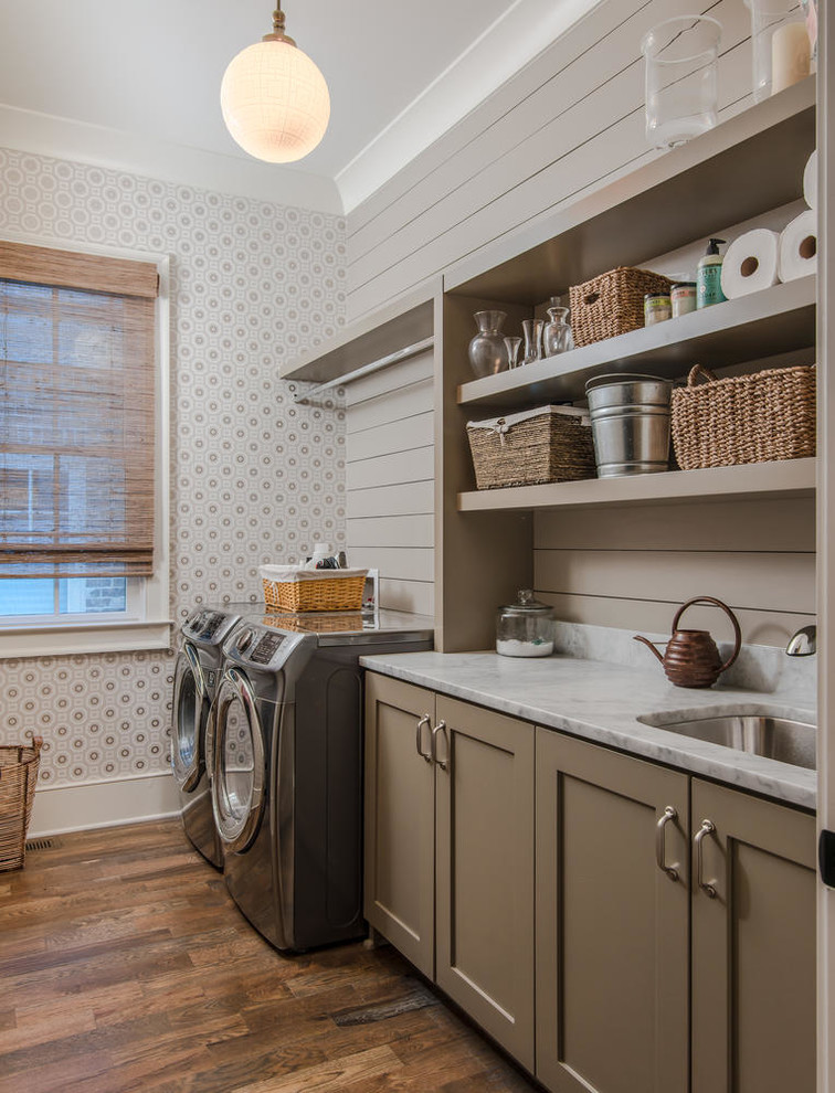 Inspiration for a farmhouse single-wall separated utility room in Nashville with a submerged sink, brown cabinets, dark hardwood flooring, a side by side washer and dryer, brown floors, shaker cabinets and grey walls.