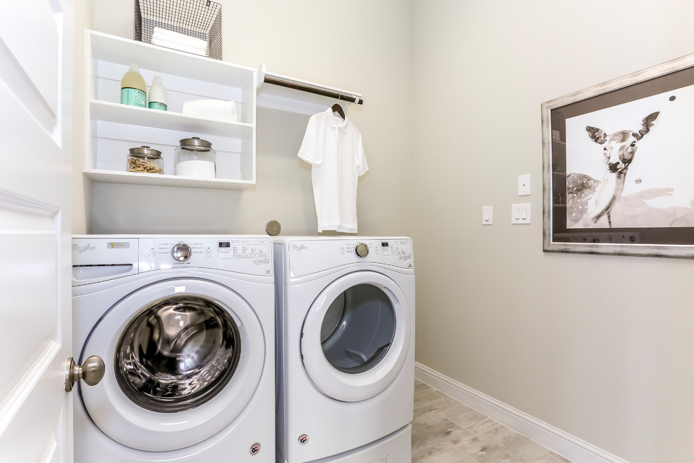 Inspiration for a mid-sized contemporary single-wall ceramic tile and beige floor dedicated laundry room remodel in Houston with open cabinets, white cabinets, a side-by-side washer/dryer and beige walls