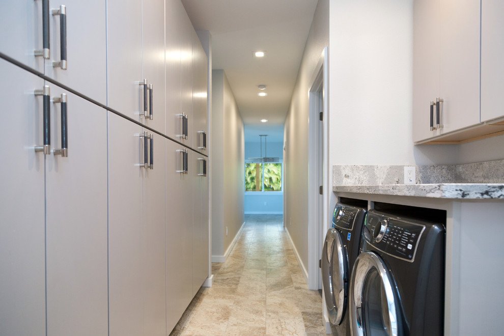 This is an example of a small modern laundry cupboard in Hawaii with grey cabinets and granite worktops.