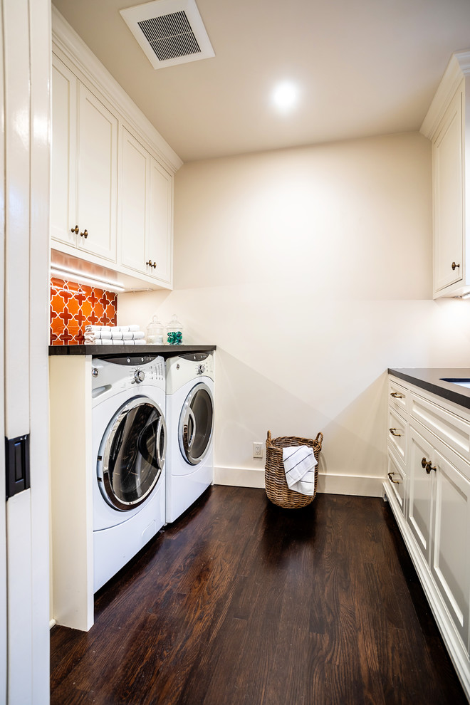 Photo of a medium sized traditional u-shaped separated utility room in Los Angeles with a submerged sink, shaker cabinets, white cabinets, beige walls, dark hardwood flooring, a side by side washer and dryer, black worktops and granite worktops.