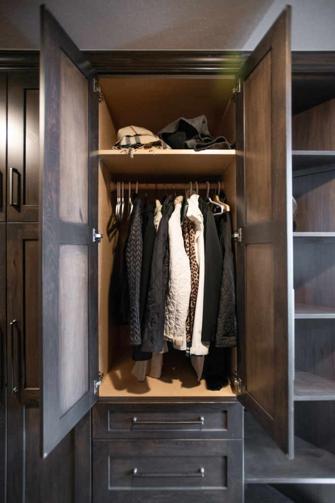 Photo of a large rural wardrobe in Other with flat-panel cabinets, dark wood cabinets, slate flooring and multi-coloured floors.