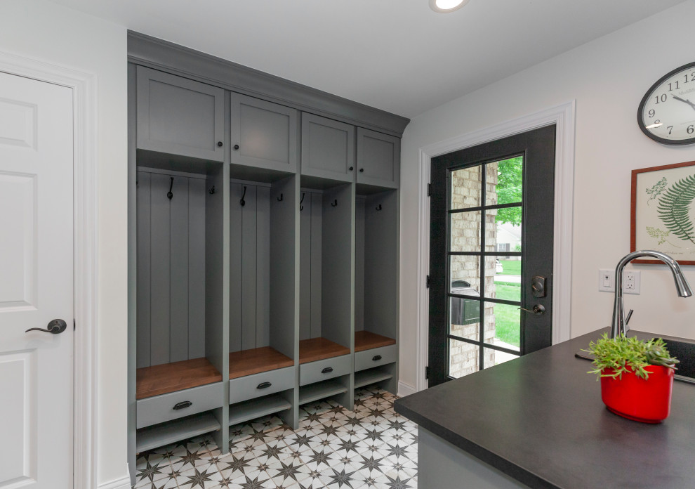 Medium sized u-shaped utility room in Chicago with a built-in sink, shaker cabinets, grey cabinets, engineered stone countertops, white walls, ceramic flooring, a side by side washer and dryer, multi-coloured floors and black worktops.