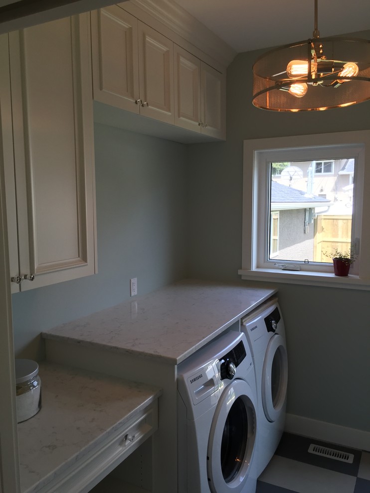Inspiration for a mid-sized timeless single-wall porcelain tile dedicated laundry room remodel in Calgary with recessed-panel cabinets, white cabinets, quartz countertops, gray walls and a side-by-side washer/dryer