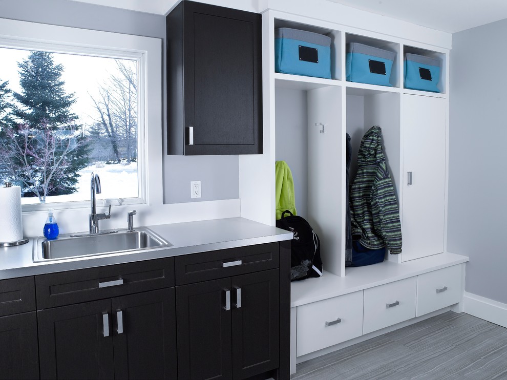 Inspiration for a mid-sized transitional utility room remodel in New York with a drop-in sink, shaker cabinets, black cabinets and gray walls