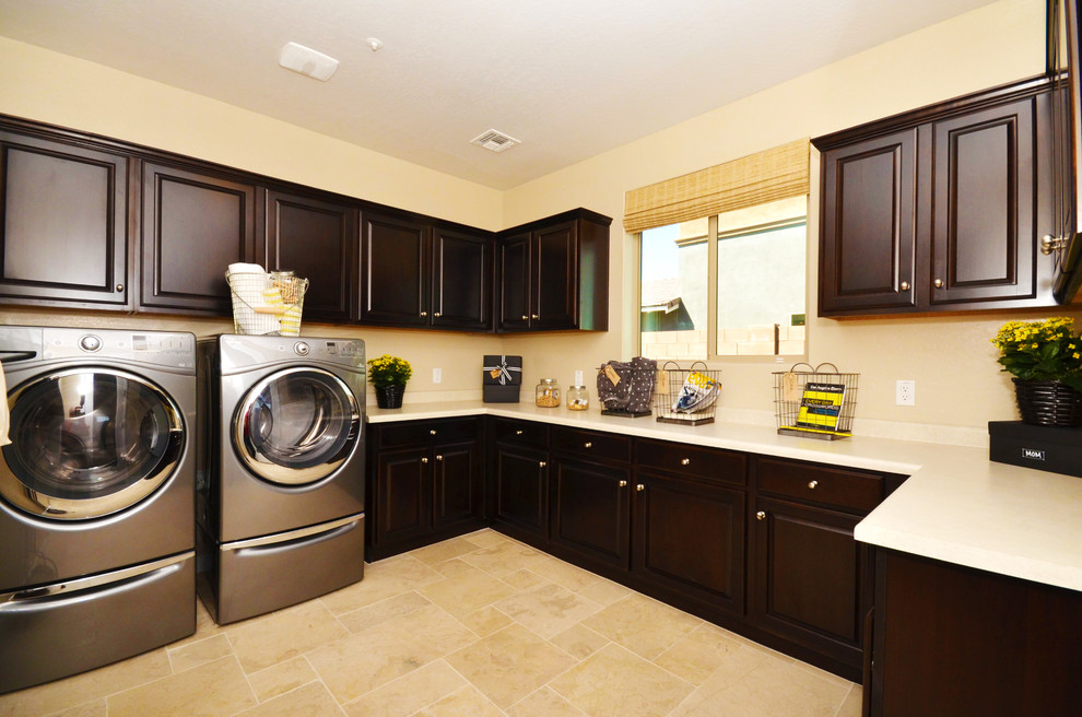 Mid-sized tuscan u-shaped ceramic tile utility room photo in Phoenix with raised-panel cabinets, dark wood cabinets, laminate countertops, beige walls and a side-by-side washer/dryer