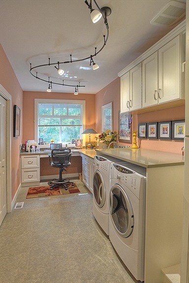 シアトルにある広いコンテンポラリースタイルのおしゃれな家事室 (ll型、アンダーカウンターシンク、フラットパネル扉のキャビネット、白いキャビネット、クオーツストーンカウンター、オレンジの壁、セラミックタイルの床、左右配置の洗濯機・乾燥機) の写真