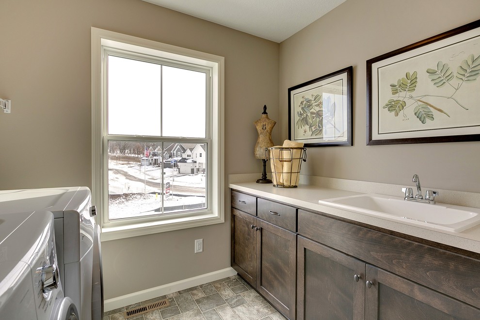 Laundry room - laundry room idea in Minneapolis with dark wood cabinets and beige walls
