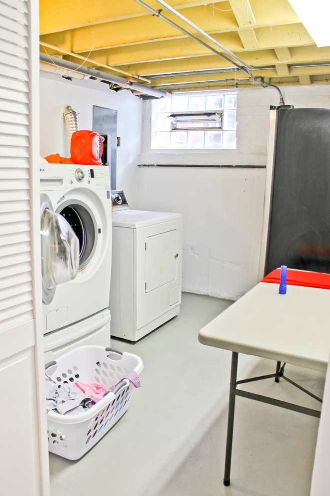 Large elegant concrete floor laundry room photo in Chicago with white walls