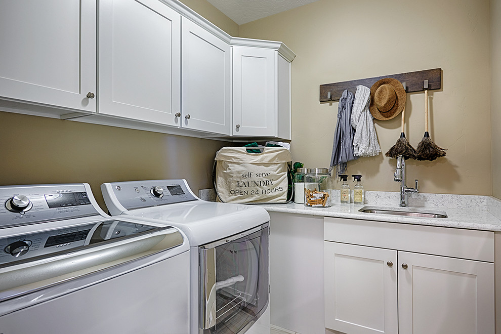 Inspiration for a contemporary separated utility room in Denver with white cabinets and a side by side washer and dryer.