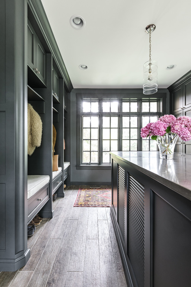 Design ideas for a large traditional u-shaped utility room in Chicago with shaker cabinets, dark hardwood flooring, black cabinets and grey walls.
