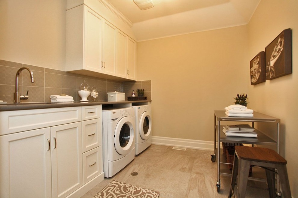 Medium sized classic single-wall separated utility room in Toronto with shaker cabinets, white cabinets, laminate countertops, beige walls, a side by side washer and dryer, a submerged sink, ceramic flooring and brown floors.