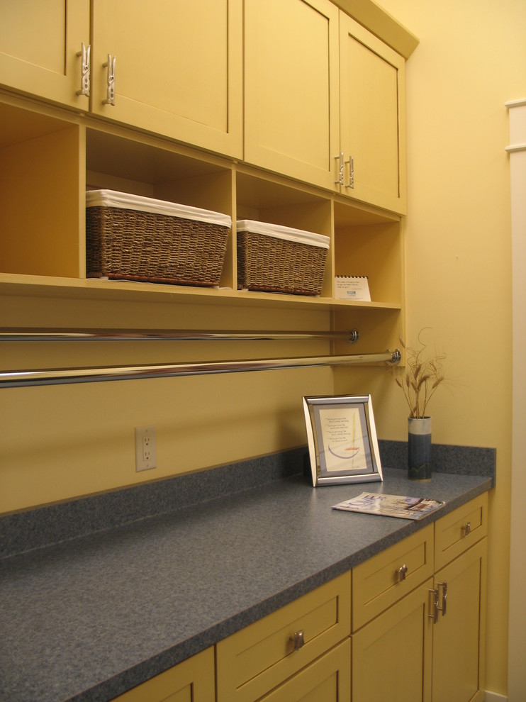 Photo of a medium sized classic utility room in Indianapolis with recessed-panel cabinets and laminate countertops.