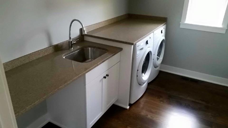 Medium sized traditional single-wall separated utility room in Minneapolis with a submerged sink, flat-panel cabinets, white cabinets, engineered stone countertops, white walls, dark hardwood flooring and a side by side washer and dryer.