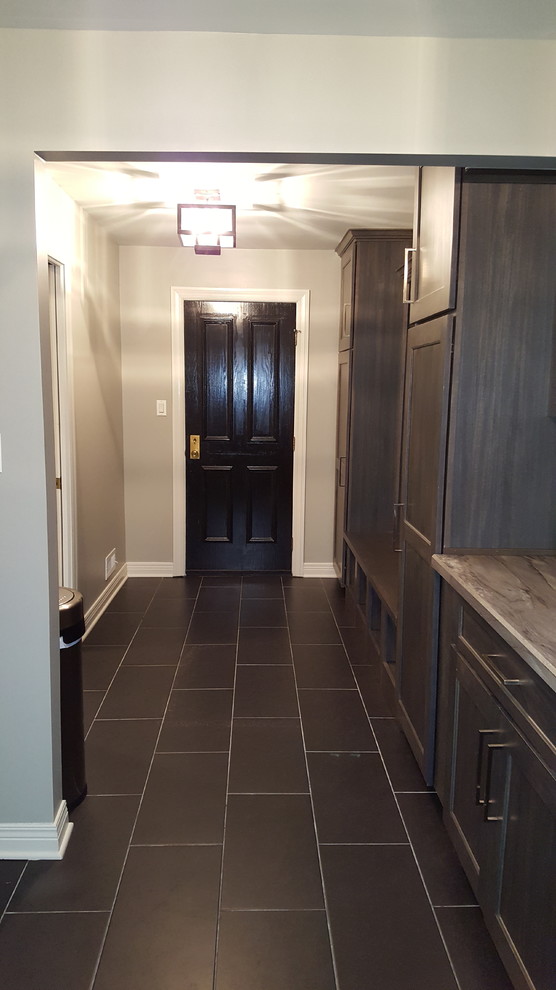 This is an example of a traditional utility room in Chicago with a built-in sink, shaker cabinets, grey cabinets, laminate countertops, grey walls, porcelain flooring and a side by side washer and dryer.