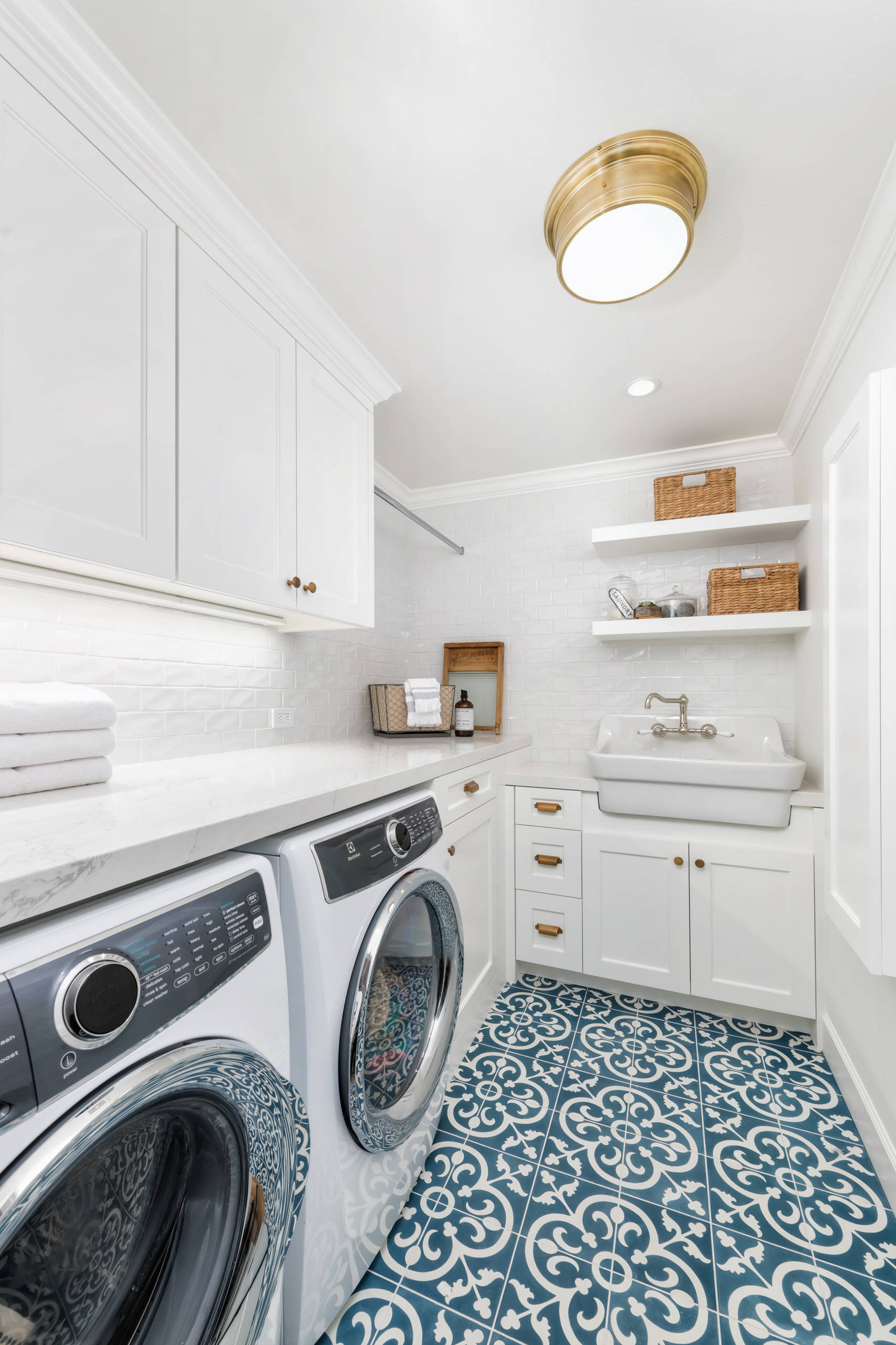 Classic cottage laundry room features a white and gray granite