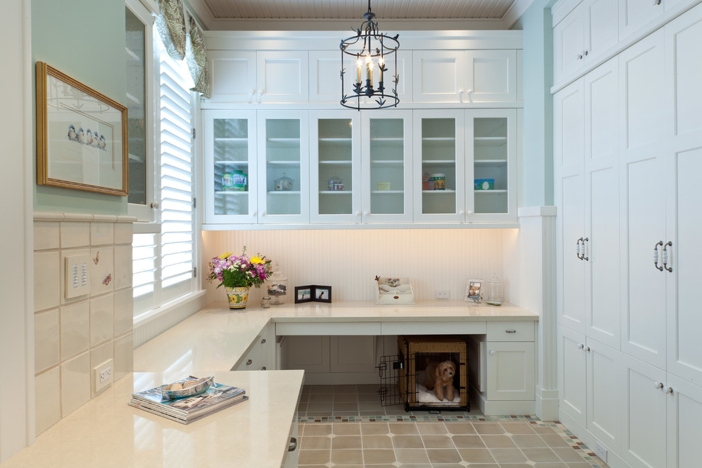 Elegant beige floor laundry room photo in Miami with white cabinets and beige countertops