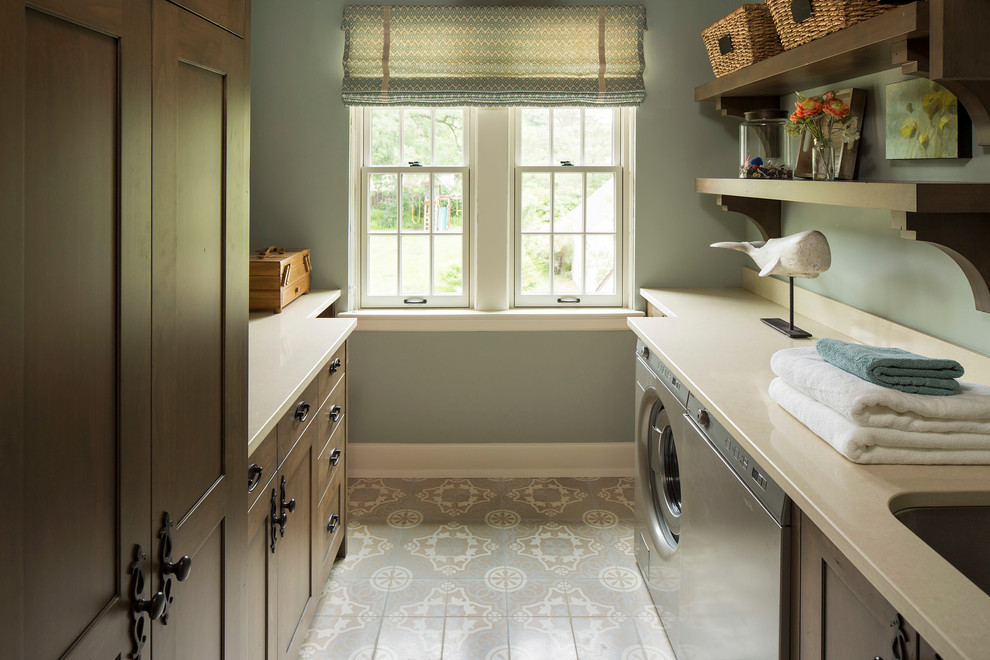 Elegant galley gray floor dedicated laundry room photo in Minneapolis with an undermount sink, shaker cabinets, dark wood cabinets, a side-by-side washer/dryer, beige countertops and gray walls