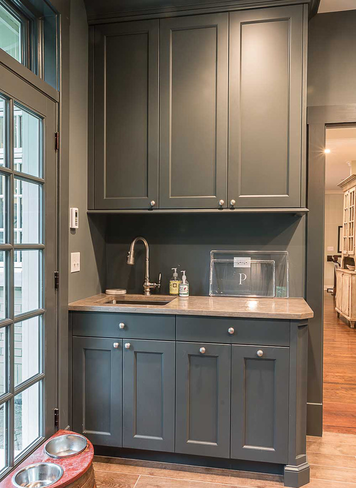 Inspiration for a large scandinavian u-shaped medium tone wood floor utility room remodel in Chicago with an undermount sink, flat-panel cabinets, gray cabinets, quartz countertops, gray walls and a side-by-side washer/dryer