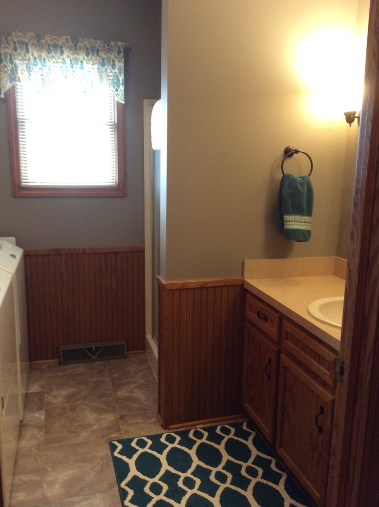 Small transitional galley utility room photo in Grand Rapids with a single-bowl sink, beaded inset cabinets, medium tone wood cabinets, laminate countertops, gray walls and a side-by-side washer/dryer