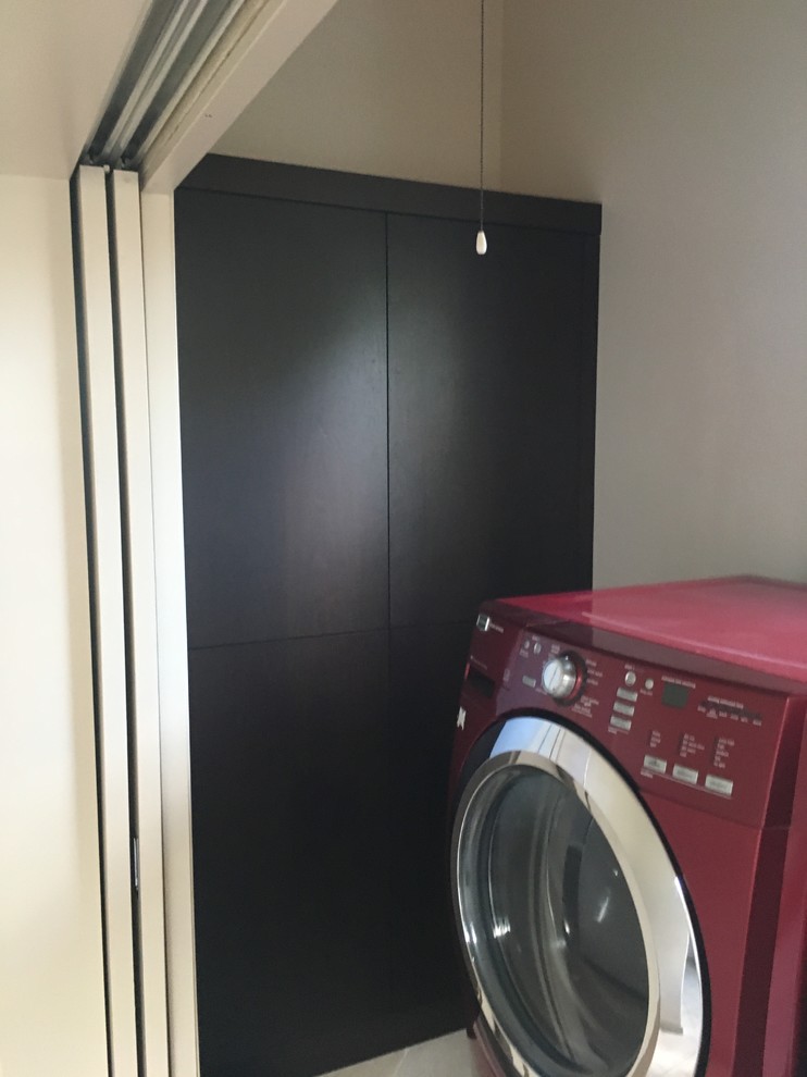 Medium sized contemporary separated utility room in Hawaii with flat-panel cabinets, dark wood cabinets, beige walls, ceramic flooring, a side by side washer and dryer and beige floors.