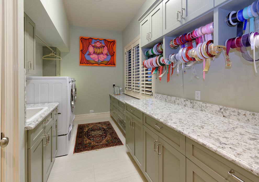 Inspiration for a small coastal galley ceramic tile utility room remodel in Miami with a drop-in sink, shaker cabinets, green cabinets, quartz countertops, a side-by-side washer/dryer and gray walls