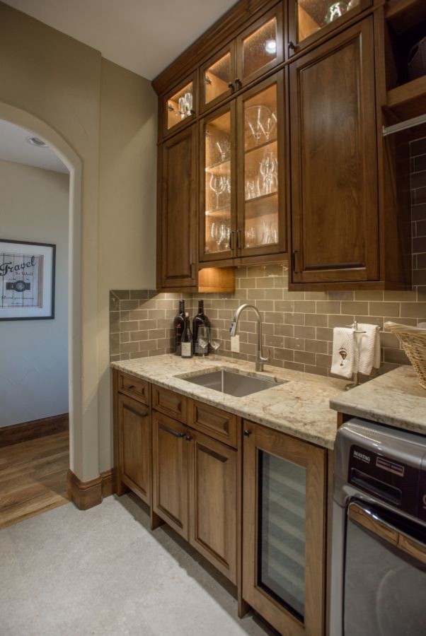 Large elegant galley concrete floor and gray floor utility room photo in Denver with an undermount sink, raised-panel cabinets, dark wood cabinets, granite countertops, gray walls and a side-by-side washer/dryer