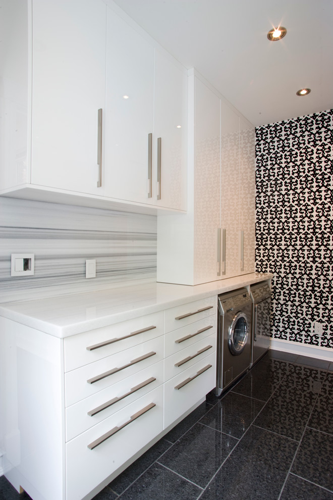Design ideas for a medium sized contemporary galley utility room in Calgary with flat-panel cabinets, white cabinets, marble worktops, multi-coloured walls, a side by side washer and dryer and ceramic flooring.