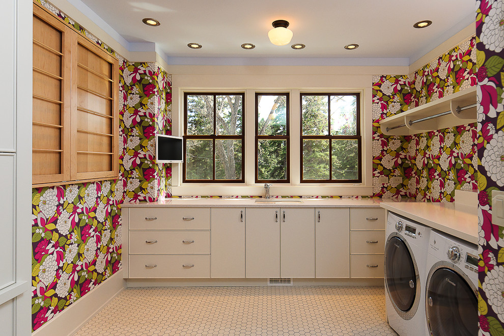 Idéer för att renovera en stor funkis l-formad tvättstuga enbart för tvätt, med en undermonterad diskho, släta luckor, beige skåp, bänkskiva i kvarts, flerfärgade väggar, klinkergolv i keramik och en tvättmaskin och torktumlare bredvid varandra