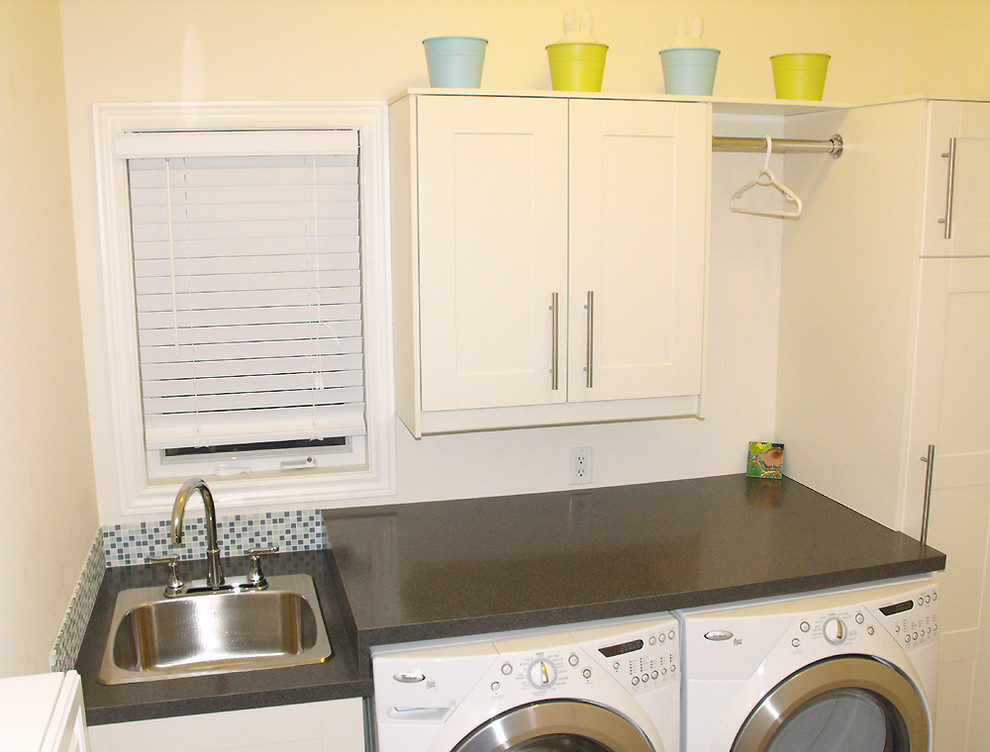 Example of a trendy laundry room design in Toronto with a side-by-side washer/dryer and gray countertops
