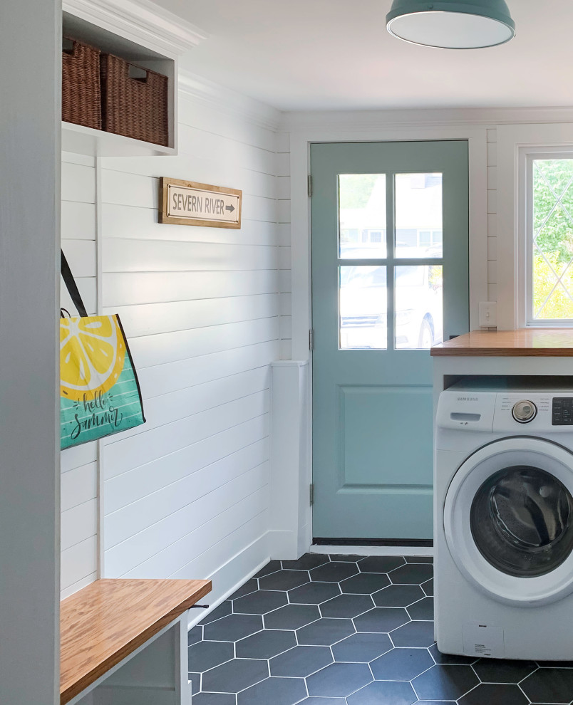 Design ideas for a medium sized traditional utility room in DC Metro with white cabinets, wood worktops, tonge and groove splashback, white walls, ceramic flooring, a side by side washer and dryer, black floors, brown worktops and tongue and groove walls.