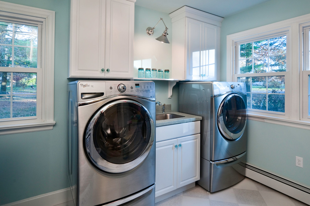 Example of a small transitional single-wall dedicated laundry room design in Philadelphia with white cabinets and a side-by-side washer/dryer