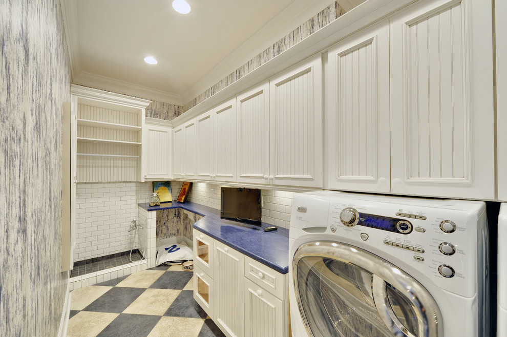 Laundry room - coastal laundry room idea in Philadelphia with white cabinets