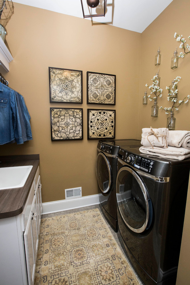 Utility room - eclectic utility room idea in Louisville with a drop-in sink, beige walls and a side-by-side washer/dryer