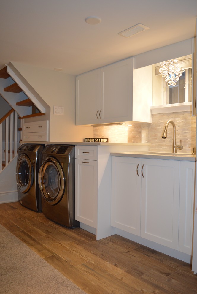 Inspiration for a medium sized traditional single-wall utility room in Toronto with an utility sink, shaker cabinets, white cabinets, quartz worktops, grey walls, ceramic flooring and a side by side washer and dryer.
