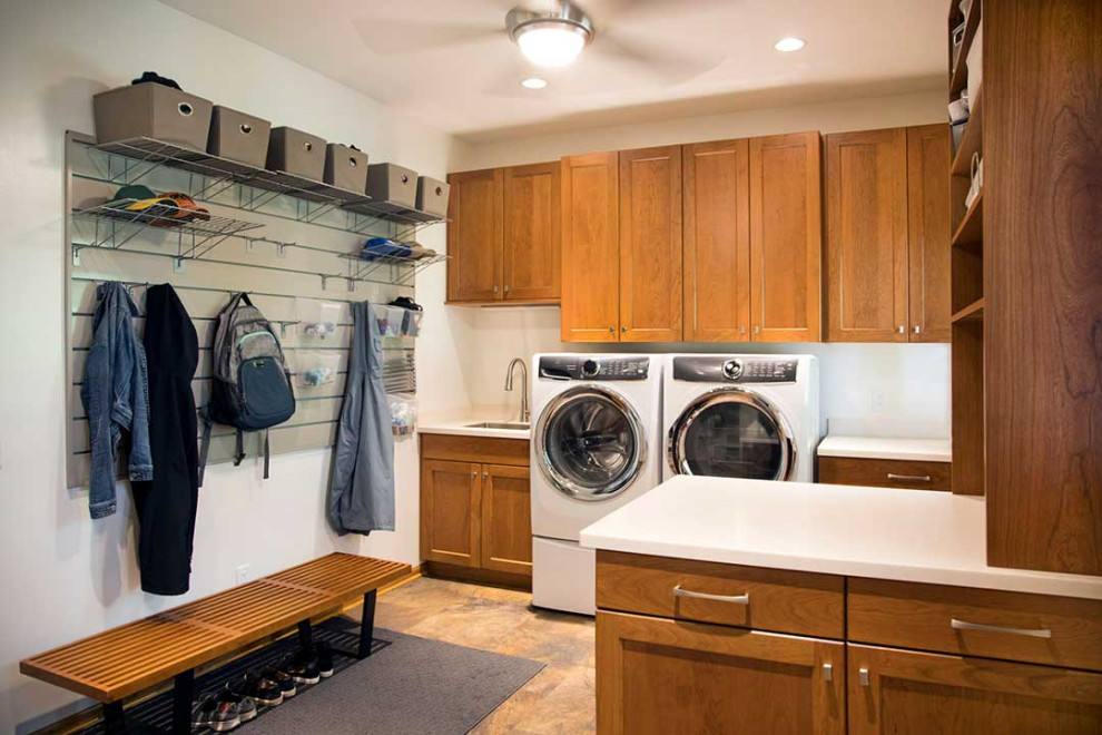 Inspiration for a large classic single-wall utility room in Other with a submerged sink, shaker cabinets, medium wood cabinets, composite countertops, beige walls, ceramic flooring, a side by side washer and dryer, beige floors and white worktops.