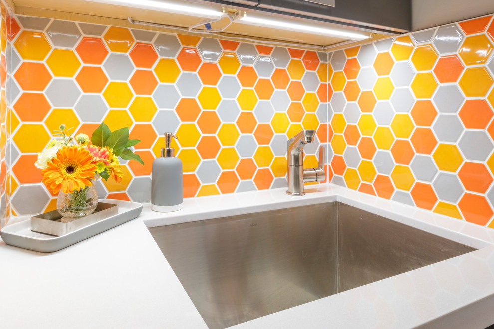 Inspiration for a small 1960s galley porcelain tile and gray floor laundry room remodel in San Francisco with an undermount sink, flat-panel cabinets, gray cabinets, quartz countertops, gray walls, a side-by-side washer/dryer and white countertops