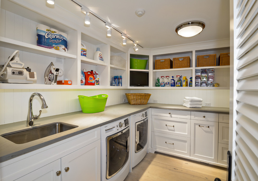Example of a mid-sized classic l-shaped light wood floor dedicated laundry room design in Miami with white cabinets, white walls, a side-by-side washer/dryer, gray countertops, shaker cabinets and an undermount sink