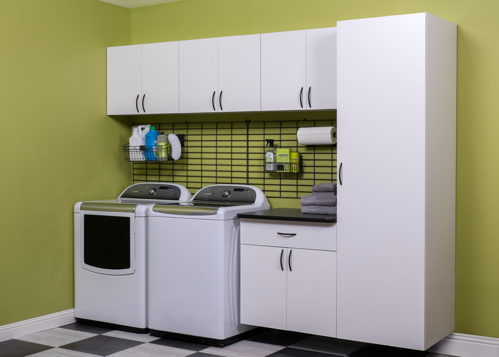 This is an example of a medium sized traditional u-shaped utility room in Boston with white cabinets, composite countertops, green walls, ceramic flooring, a side by side washer and dryer and flat-panel cabinets.