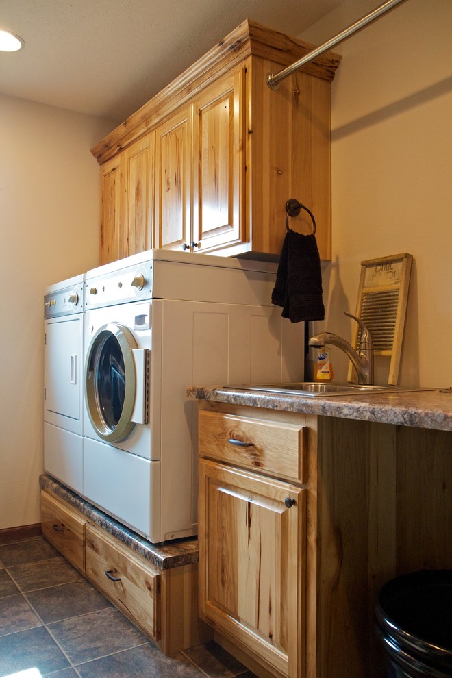 Utility room - mid-sized single-wall utility room idea in Other with a drop-in sink, raised-panel cabinets, laminate countertops, a side-by-side washer/dryer and medium tone wood cabinets