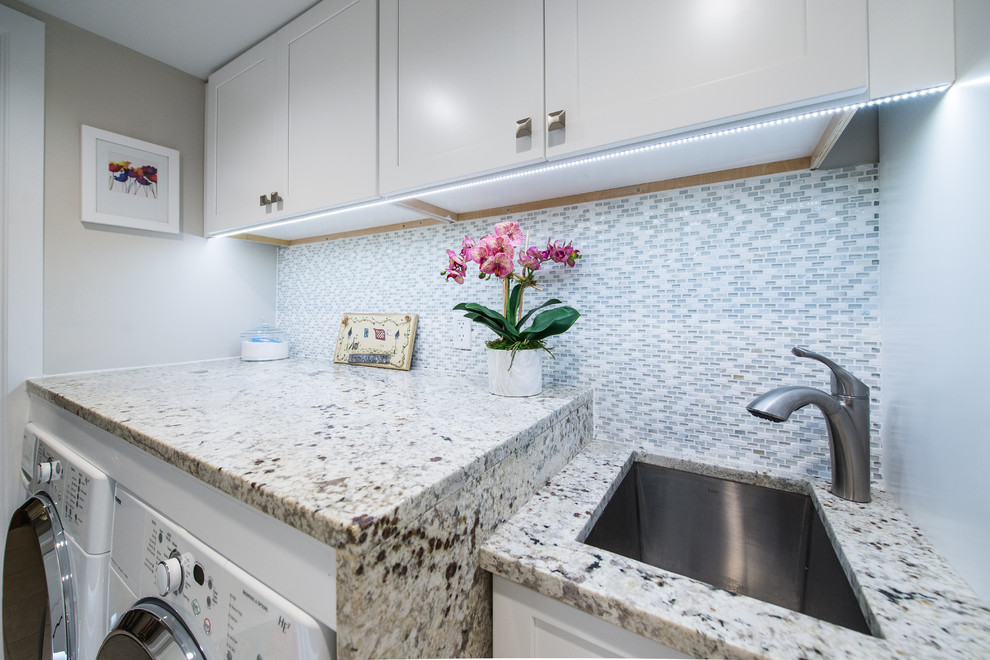 Small transitional galley ceramic tile utility room photo in New York with an undermount sink, shaker cabinets, white cabinets, granite countertops, white walls and a side-by-side washer/dryer